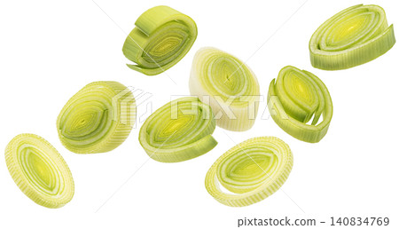 Falling sliced leek isolated on white background, green onion rings, healthy salad ingredient Falling sliced leek isolated on white background, green onion rings, healthy salad ingredient 140834769