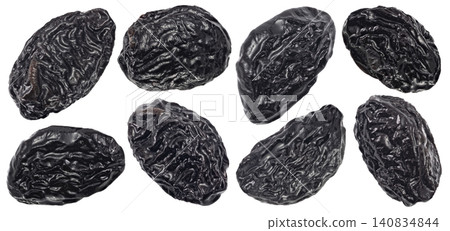 Whole dried prunes isolated on white background with clipping path, falling sweet black dried plums Whole dried prunes isolated on white background with clipping path, falling sweet black dried plums 140834844