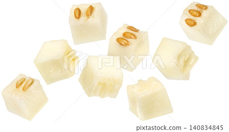 Falling sweet melon cubes isolated on white background, falling juicy ripe cantaloupe pieces Falling sweet melon cubes isolated on white background, falling juicy ripe cantaloupe pieces 140834845