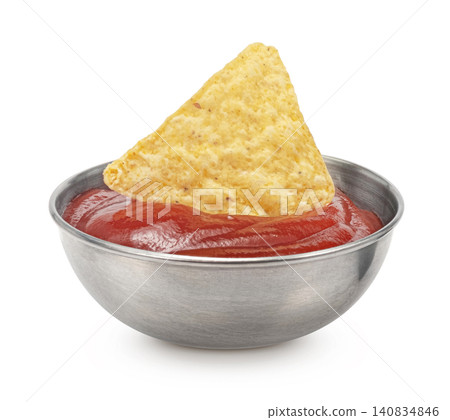Crispy tortilla chip dipped in tomato ketchup isolated on white background, nacho chip 140834846