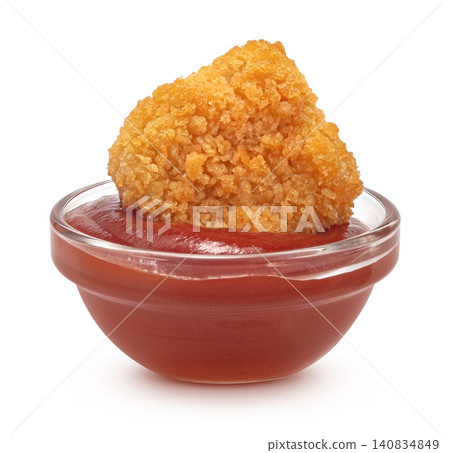 Crispy chicken nugget dipped in tomato ketchup sauce isolated on white background, fast food snack with golden breaded texture for menu and advertising concept Crispy chicken nugget dipped in tomato ketchup sauce isolated on white background, fast food snack with golden breaded texture for menu and advertising concept 140834849