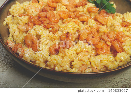 risotto with shrimp, in a bowl, on a textured surface, with a side dish of fresh coriander, homemade, no people, risotto with shrimp, in a bowl, on a textured surface, with a side dish of fresh coriander, homemade, no people, 140835027