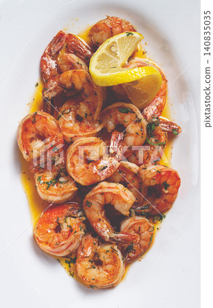 fried tiger prawns, jumbo, in garlic sauce, in butter, with herbs, on a white plate, homemade, no people, fried tiger prawns, jumbo, in garlic sauce, in butter, with herbs, on a white plate, homemade, no people, 140835035