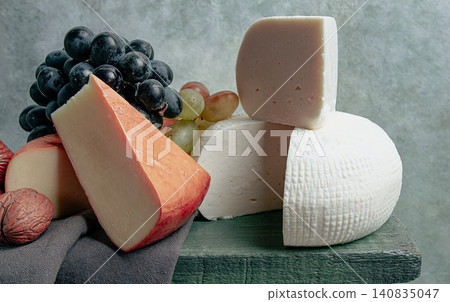 Georgian cheese, Imeretian and smoked suluguni, grapes, nuts, on a cutting board, Georgian cuisine, no people, Georgian cheese, Imeretian and smoked suluguni, grapes, nuts, on a cutting board, Georgian cuisine, no people, 140835047