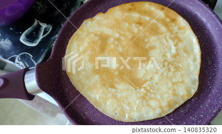 Process of making delicious Russian blini or French crepes for breakfast, home cooking concept. Process of making delicious Russian blini or French crepes for breakfast, home cooking concept. 140835320