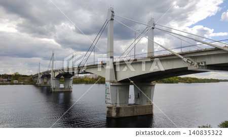 Industrial cityscape with a large concrete bridge reflecting in calm river water. Industrial cityscape with a large concrete bridge reflecting in calm river water. 140835322