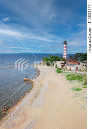 Beautiful landscape with a lighthouse tower on the seashore. Beautiful landscape with a lighthouse tower on the seashore. 140835323