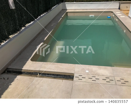Swimming pool with unkempt green water and drainage issues Swimming pool with unkempt green water and drainage issues 140835557