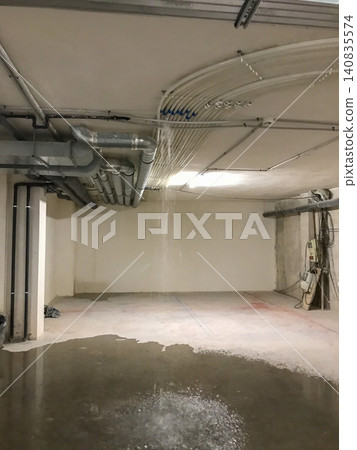 Water leaking from building ceiling causing flood damage 140835574