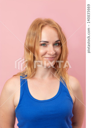 Confident young woman with beautiful green eyes and blonde hair posing with a smiling expression, showcasing feelings of happiness, positivity, and friendliness Confident young woman with beautiful green eyes and blonde hair posing with a smiling expression, showcasing feelings of happiness, positivity, and friendliness 140835669