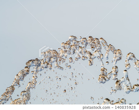 Splashes and jets of water against light background. Splashes and jets of water against light background. 140835928