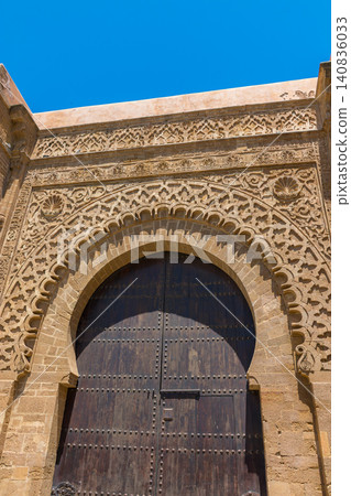 The enormous wooden and stone Bab Udaya gate welcomes visitors to the Kasbah of the Udayas in Morocco The enormous wooden and stone Bab Udaya gate welcomes visitors to the Kasbah of the Udayas in Morocco 140836033