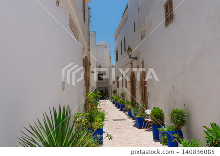 A narrow street with white walls leads to a beautiful blue door in the Kasbah of Rabat, Morocco. A narrow street with white walls leads to a beautiful blue door in the Kasbah of Rabat, Morocco. 140836085