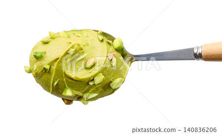 spoon of pistachio spread isolated on white background spoon of pistachio spread isolated on white background 140836206