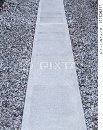 Straight concrete sidewalk and gravel path | Simple composition background material 140836253