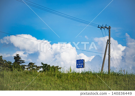 A bicycle parking area sign under a blue sky and early summer scenery. A bicycle parking area sign under a blue sky and early summer scenery. 140836449