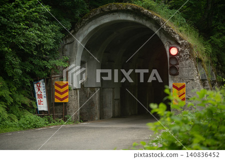 The entrance to an old tunnel with a red light and a "No Entry" sign. The entrance to an old tunnel with a red light and a "No Entry" sign. 140836452
