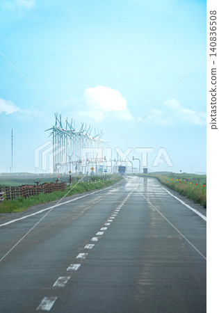 A summer scene along Hokkaido Prefectural Road 106, the Wakkanai-Teshio Line, featuring a cluster of wind turbines for wind power generation. A summer scene along Hokkaido Prefectural Road 106, the Wakkanai-Teshio Line, featuring a cluster of wind turbines for wind power generation. 140836508
