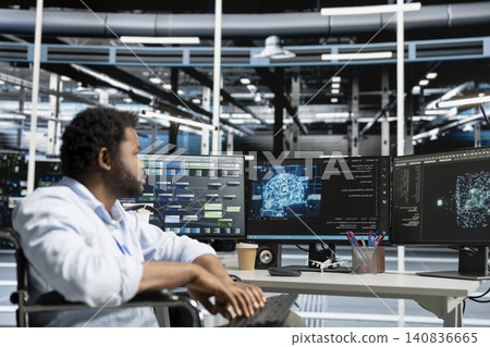 Engineer with paraplegia uses AI visualization tools in an inclusive data center to find bugs and detect system errors. 140836665