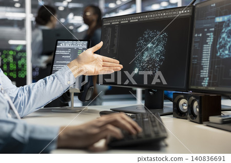 Data center programmer uses a desktop computer in a data center to manage AI virtualization and optimize server infrastructure. Data center programmer uses a desktop computer in a data center to manage AI virtualization and optimize server infrastructure. 140836691