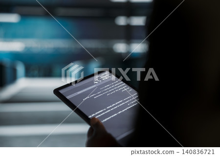 IT expert uses a digital tablet in a sustainable data center to apply energy efficient solutions and reduce carbon footprint. IT expert uses a digital tablet in a sustainable data center to apply energy efficient solutions and reduce carbon footprint. 140836721
