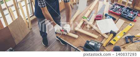 Banner DIY craftsperson asian man working wood heap carpenter objects woodwork desk. Banner Architect man hands ruler measure home improvement. Wood carpenter construction workshop with copy space Banner DIY craftsperson asian man working wood heap carpenter objects woodwork desk. Banner Architect man hands ruler measure home improvement. Wood carpenter construction workshop with copy space 140837293