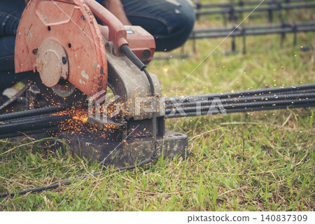 Construction Worker hands using Welding machinery iron metal sparking. Men hands wear protective glove Hot flame metal work cutting fire iron workshop. Locksmith use Welding machine cut metal process Construction Worker hands using Welding machinery iron metal sparking. Men hands wear protective glove Hot flame metal work cutting fire iron workshop. Locksmith use Welding machine cut metal process 140837309