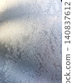 Frost on a windowpane on a snowy day; winter; texture; background; wallpaper; material. 140837612