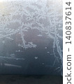 Frost on a windowpane on a snowy day; winter; texture; background; wallpaper; material. 140837614
