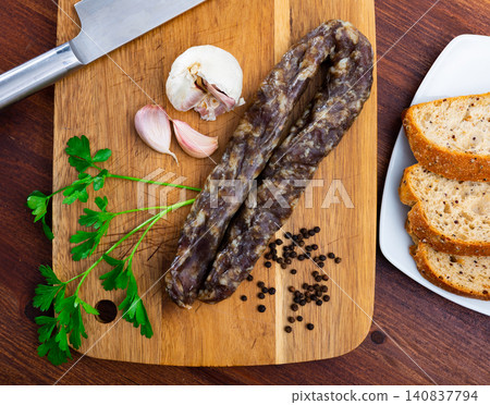 Dried pork meat sausage served on wooden table Dried pork meat sausage served on wooden table 140837794