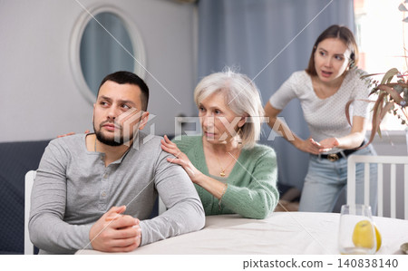 Quarrel between husband and wife, senior mother comforting adult son Quarrel between husband and wife, senior mother comforting adult son 140838140