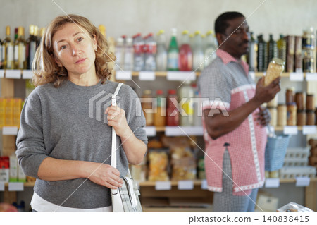 Adult woman choosing food in grocery store Adult woman choosing food in grocery store 140838415