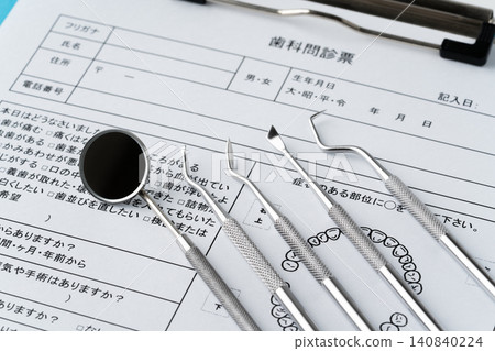 Close-up of dental questionnaires and medical instruments (scalers) Close-up of dental questionnaires and medical instruments (scalers) 140840224