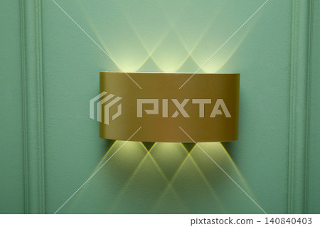 Elegant wall fixture emanates soft light in modern environment. Illumination concept Elegant wall fixture emanates soft light in modern environment. Illumination concept 140840403