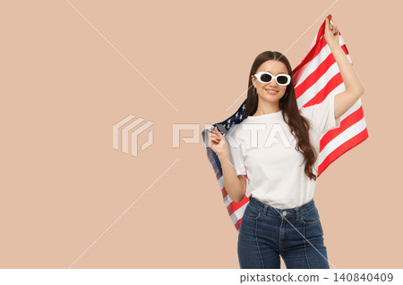 Young woman waves American flag. Celebration of freedom and unity concept Young woman waves American flag. Celebration of freedom and unity concept 140840409