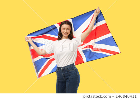 Young woman waves British flag. Celebration of travel and cultural pride concept Young woman waves British flag. Celebration of travel and cultural pride concept 140840411