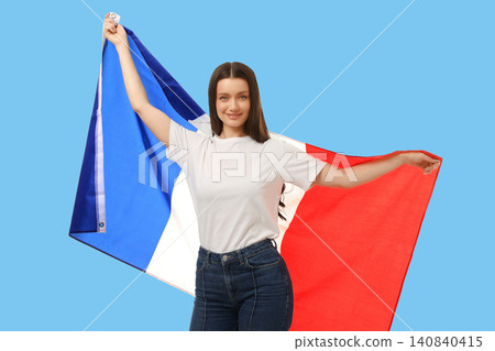 Young woman waves French flag, expressing joy and enthusiasm Young woman waves French flag, expressing joy and enthusiasm 140840415
