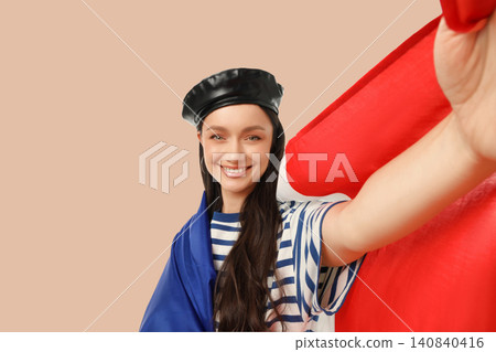 Young woman waves flags joyfully. Vacation spirit and travel concept Young woman waves flags joyfully. Vacation spirit and travel concept 140840416