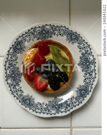 A delightful fruit tart with a buttery, flaky crust filled with creamy custard and topped with an array of fresh, vibrant fruits. Perfectly balanced between sweet and tangy, making it irresistible A delightful fruit tart with a buttery, flaky crust filled with creamy custard and topped with an array of fresh, vibrant fruits. Perfectly balanced between sweet and tangy, making it irresistible 140841022