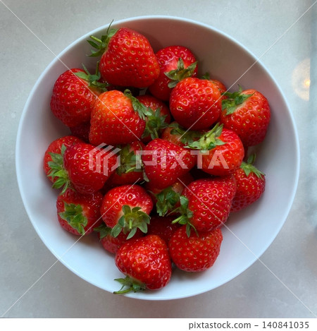 Fresh, juicy strawberries with a vibrant red color and sweet, slightly tangy flavor. Perfect for snacking, adding to desserts, smoothies, or salads, they bring a burst of natural sweetness to any dish 140841035