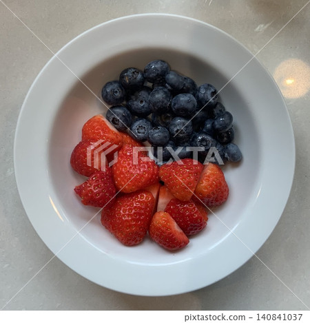 Fresh strawberries and blueberries create a vibrant mix of red and deep blue with sweet and slightly tart flavors. Their bright colors and juicy textures make them perfect for desserts, bowls, and Fresh strawberries and blueberries create a vibrant mix of red and deep blue with sweet and slightly tart flavors. Their bright colors and juicy textures make them perfect for desserts, bowls, and 140841037