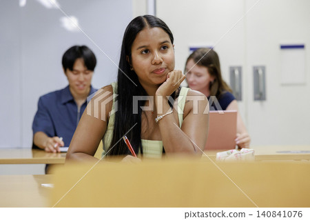 A scene of young university students studying on campus. 140841076