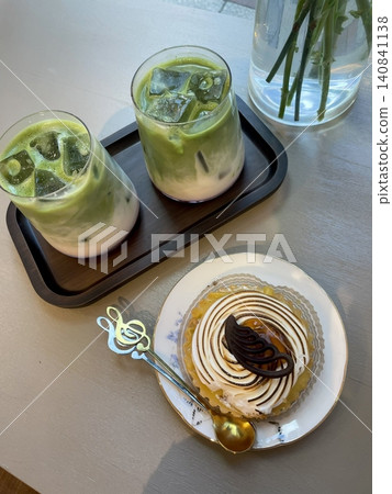 Light and creamy desserts with delicate layers, fresh fruits, and rich flavors, paired with refreshing sweet drinks. A perfect café treat for a delightful and indulgent experience. 140841138