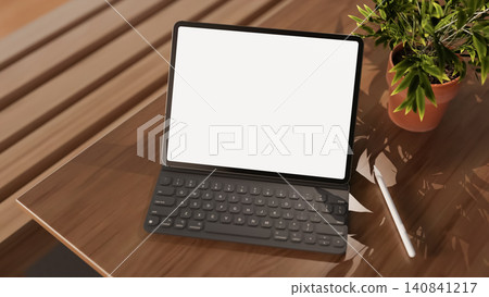 Tablet mockup with keyboard and stylus on wooden desk Tablet mockup with keyboard and stylus on wooden desk 140841217