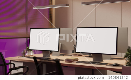 Modern office with desktop computer mockups and ambient evening lighting Modern office with desktop computer mockups and ambient evening lighting 140841242