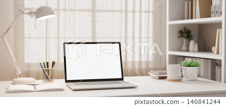 Bright home office workspace with laptop mockup on white desk Bright home office workspace with laptop mockup on white desk 140841244