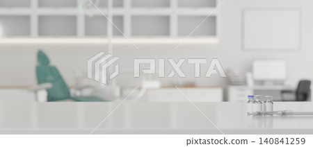 Vaccine Vials and Syringe on Medical Counter with Blurred Dental Clinic Background 140841259