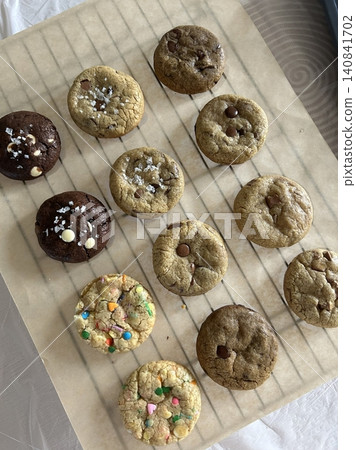 Freshly baked cookies with a golden-brown finish and chocolate chips. Perfectly crisp on the edges with a soft center, offering a delicious, comforting treat for any occasion. Freshly baked cookies with a golden-brown finish and chocolate chips. Perfectly crisp on the edges with a soft center, offering a delicious, comforting treat for any occasion. 140841702