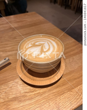 A beautifully crafted latte, featuring creamy foam art on top of rich espresso. Perfect for coffee-related projects, this image captures the warmth and inviting nature of a classic cafe experience. A beautifully crafted latte, featuring creamy foam art on top of rich espresso. Perfect for coffee-related projects, this image captures the warmth and inviting nature of a classic cafe experience. 140841817