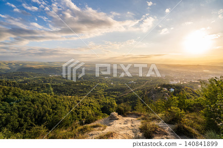 View of the mountains and Kislovodsk from the observation decks of the Kislovodsk Park. Evening sunset over the mountains of Kislovodsk. 140841899